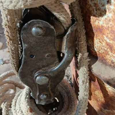 Metal Conoco barrel and a unique steel antique pully / block and tackle