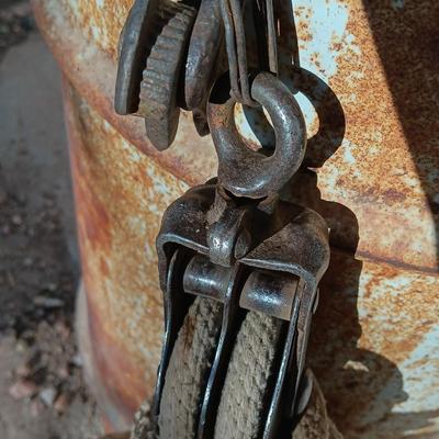Metal Conoco barrel and a unique steel antique pully / block and tackle