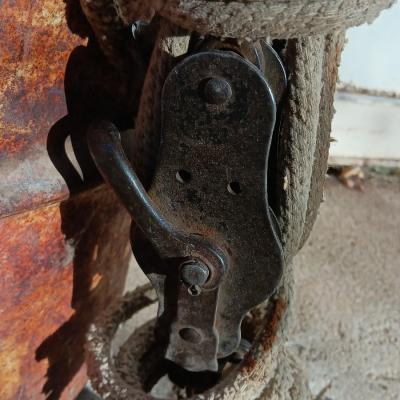 Metal Conoco barrel and a unique steel antique pully / block and tackle