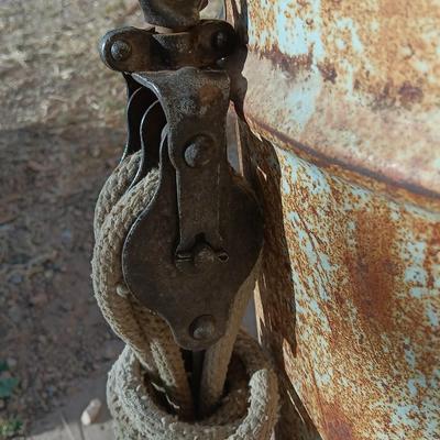 Metal Conoco barrel and a unique steel antique pully / block and tackle