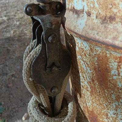 Metal Conoco barrel and a unique steel antique pully / block and tackle