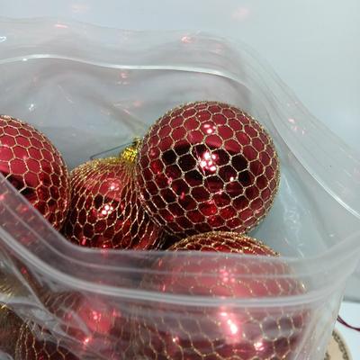 Christmas bulbs in gold colored netting and 4 ceramic ornaments