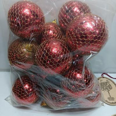 Christmas bulbs in gold colored netting and 4 ceramic ornaments