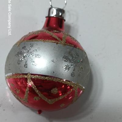 Two Christmas ornaments - one with tinsel inside and one that is indented.