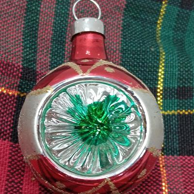 Two Christmas ornaments - one with tinsel inside and one that is indented.