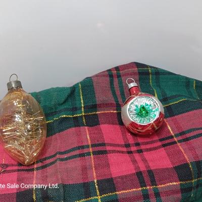 Two Christmas ornaments - one with tinsel inside and one that is indented.