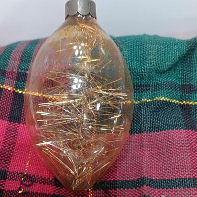 Two Christmas ornaments - one with tinsel inside and one that is indented.