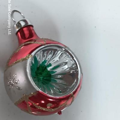Two Christmas ornaments - one with tinsel inside and one that is indented.