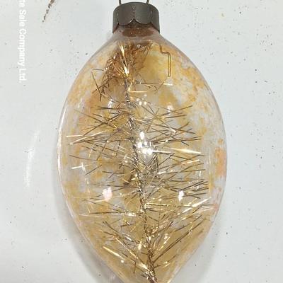 Two Christmas ornaments - one with tinsel inside and one that is indented.
