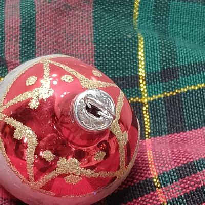 Two Christmas ornaments - one with tinsel inside and one that is indented.