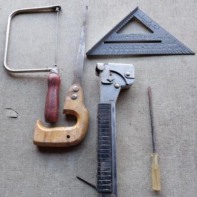 Assortment of tools - saws, wire cutters- clamp locking pilers - square and stapler