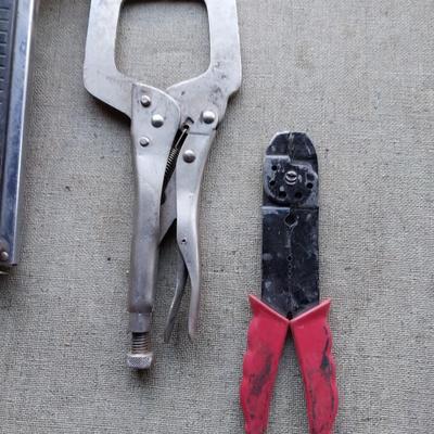 Assortment of tools - saws, wire cutters- clamp locking pilers - square and stapler