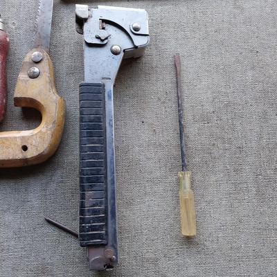 Assortment of tools - saws, wire cutters- clamp locking pilers - square and stapler