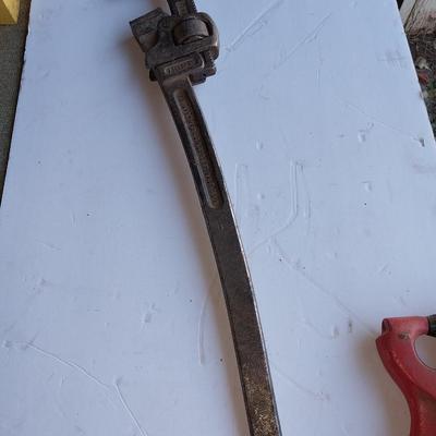 Large sized pipe wrench and a riveting tool