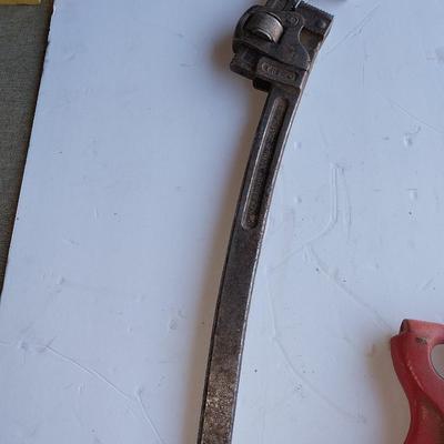 Large sized pipe wrench and a riveting tool