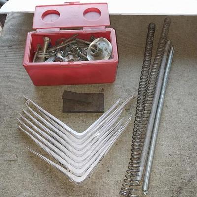 Eight White metal shelf brackets with an assortment of hardware and sharpening stones