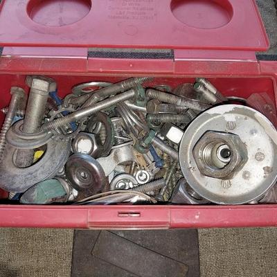 Eight White metal shelf brackets with an assortment of hardware and sharpening stones