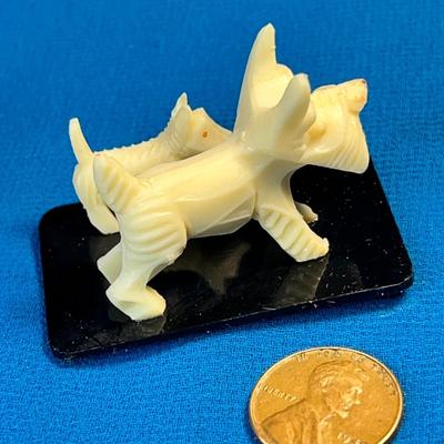 PAIR OF LITTLE CARVED WHITE SCOTTIE DOG FIGURINES ON STAND