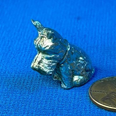 TINY METAL SITTING DOG FIGURINE