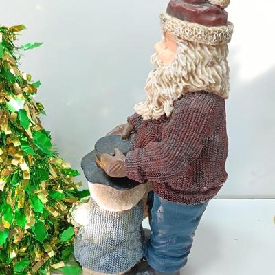 Large Santa building a snowman with plastic tinsel tree