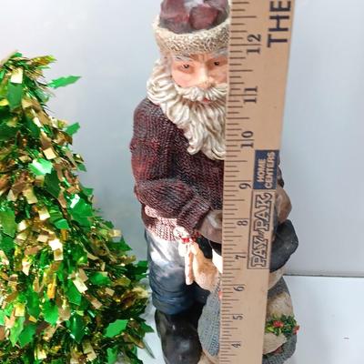 Large Santa building a snowman with plastic tinsel tree