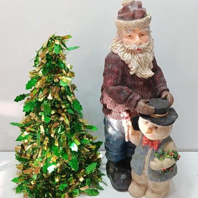 Large Santa building a snowman with plastic tinsel tree