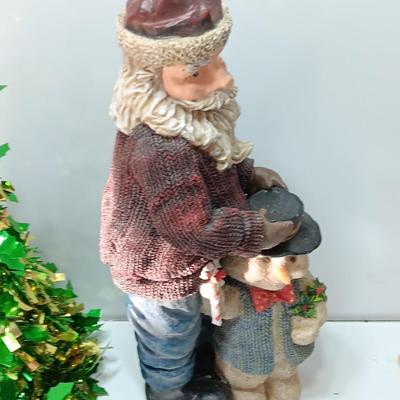 Large Santa building a snowman with plastic tinsel tree