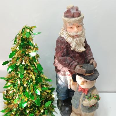 Large Santa building a snowman with plastic tinsel tree