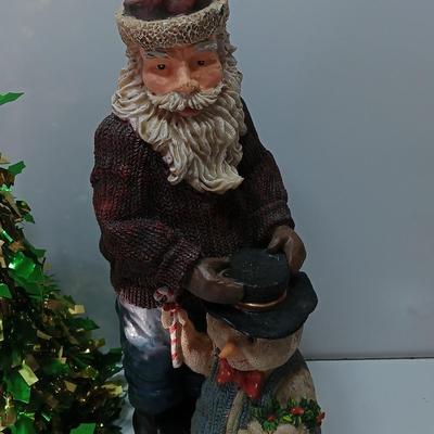 Large Santa building a snowman with plastic tinsel tree