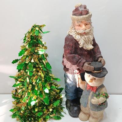 Large Santa building a snowman with plastic tinsel tree