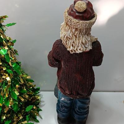 Large Santa building a snowman with plastic tinsel tree