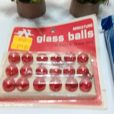 Small village trees with vintage glass balls and a package of silver string tinsel