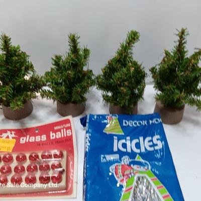 Small village trees with vintage glass balls and a package of silver string tinsel