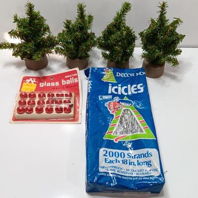 Small village trees with vintage glass balls and a package of silver string tinsel