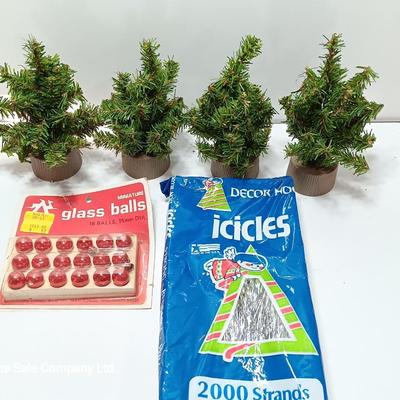 Small village trees with vintage glass balls and a package of silver string tinsel