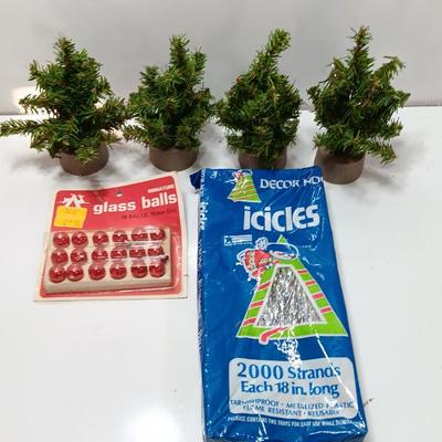 Small village trees with vintage glass balls and a package of silver string tinsel