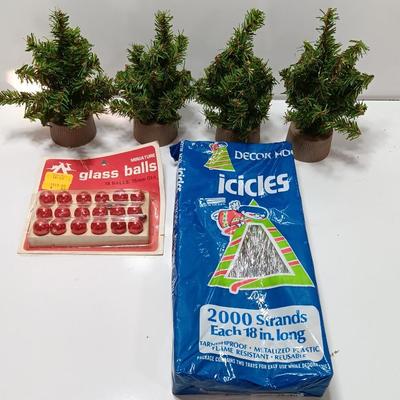 Small village trees with vintage glass balls and a package of silver string tinsel