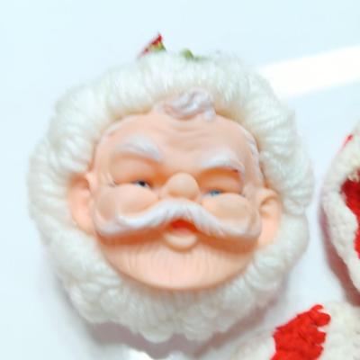 Two vintage rubber Santa face collectibles - ornament and crocheted hot pads