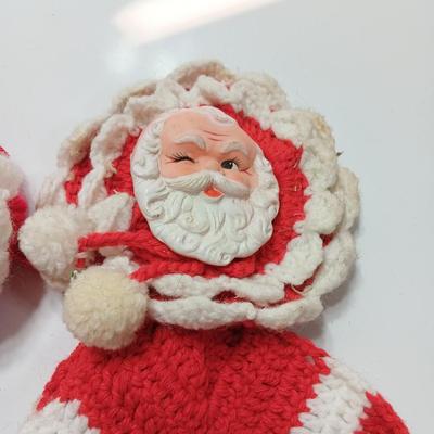 Two vintage rubber Santa face collectibles - ornament and crocheted hot pads