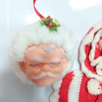 Two vintage rubber Santa face collectibles - ornament and crocheted hot pads