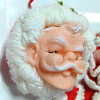 Two vintage rubber Santa face collectibles - ornament and crocheted hot pads