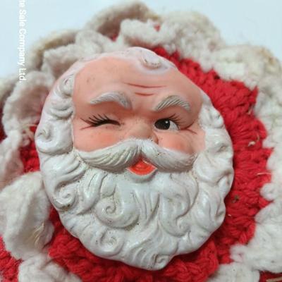 Two vintage rubber Santa face collectibles - ornament and crocheted hot pads