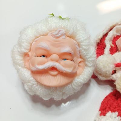 Two vintage rubber Santa face collectibles - ornament and crocheted hot pads