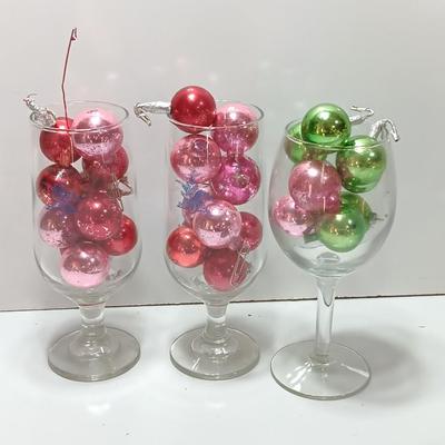 Three wine glasses with vintage glass ornaments