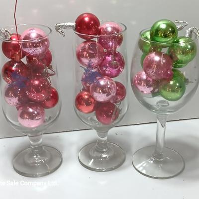 Three wine glasses with vintage glass ornaments