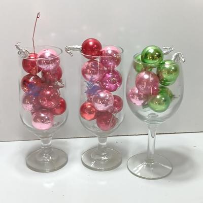 Three wine glasses with vintage glass ornaments