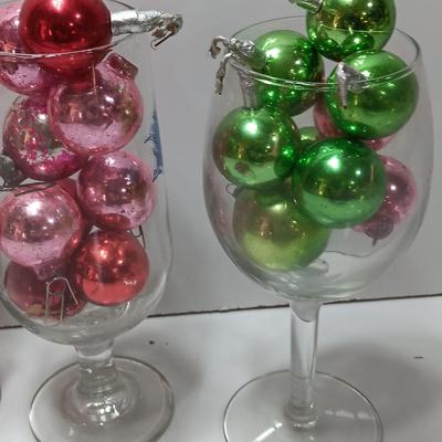 Three wine glasses with vintage glass ornaments