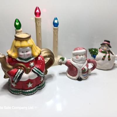 Collection of three tea pots and a working candelabra Christmas candle