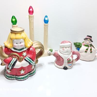 Collection of three tea pots and a working candelabra Christmas candle