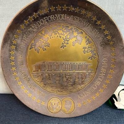 Lot No. 73, JFK metal Reed and Barton collectible plate 11 inches across and JFK paperweight